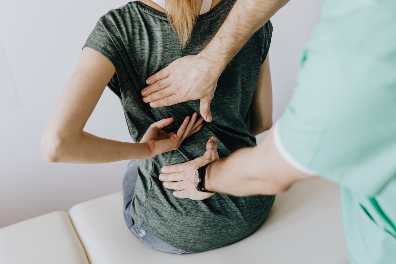 A chiropractor examining a patient